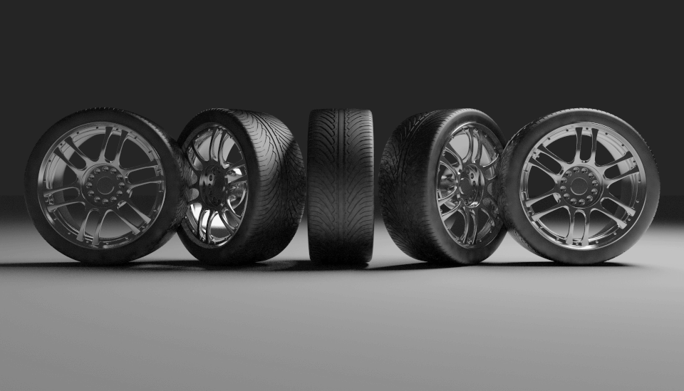 Tires in a row on a grey floor at different angles